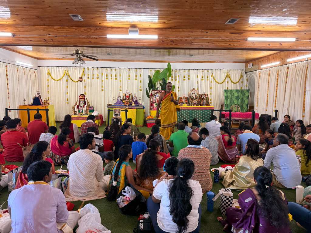 The Kalasha and deity are beautifully decorated with turmeric, kumkum, flowers, and sacred threads during the Vratham.